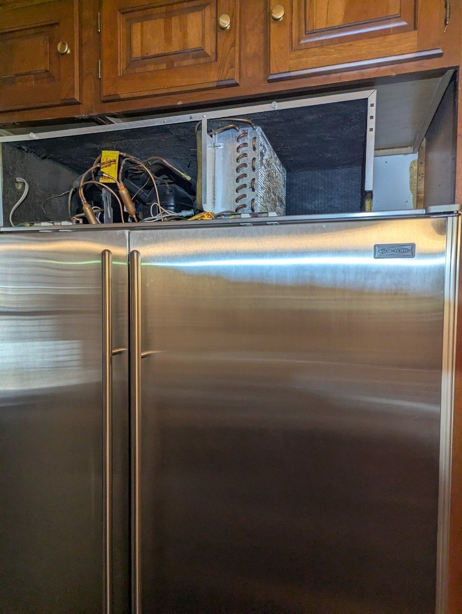 SAVA technician diagnosing Sub-Zero compressor and condenser coils during a Chicago service call
